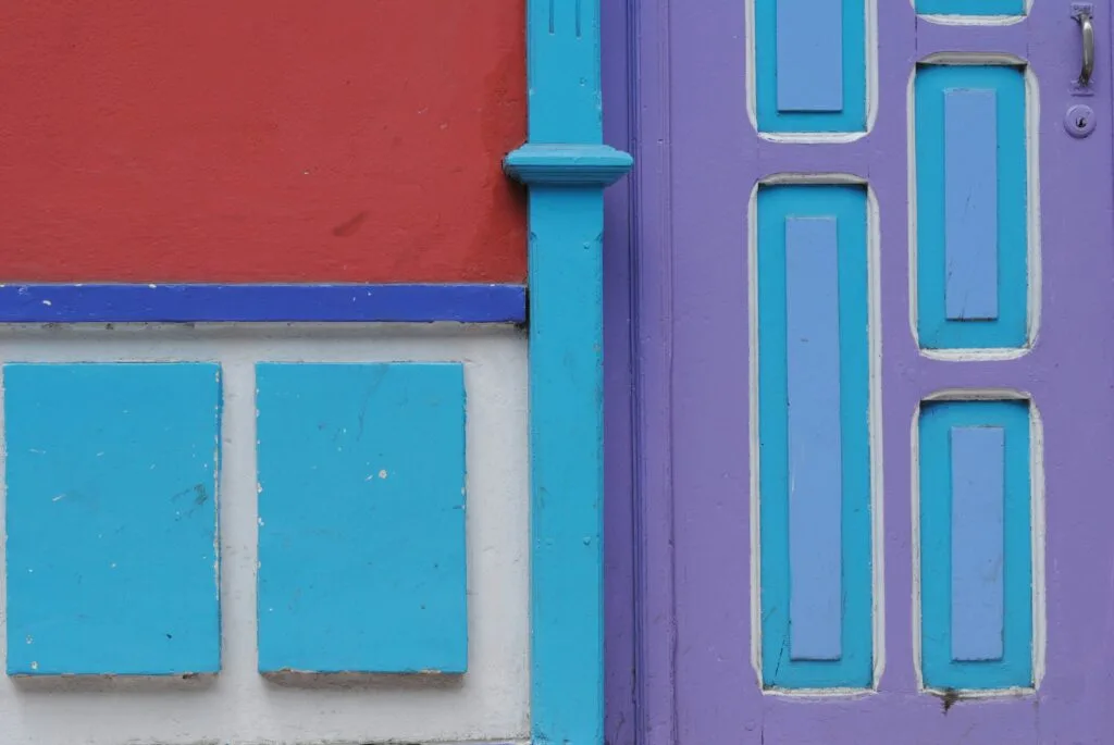 A detail of multicoloured wooden panels on a building in Loja, Ecuador