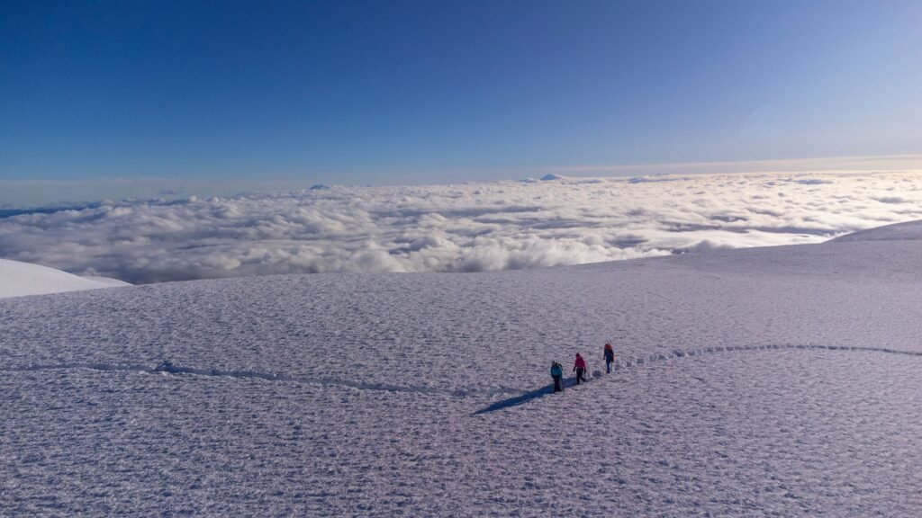 People hike along the snow on top of Chimborazo, Ecuador