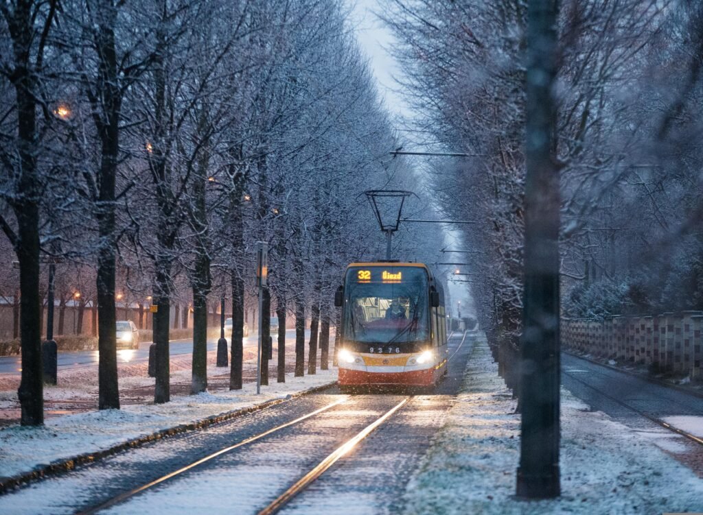 A tram runs through smow in winter in Prague, Czechia.